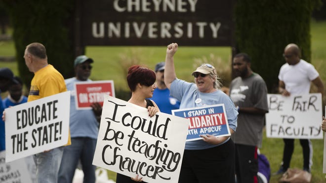 Faculty member Angela Florschuetz, center, her colleagues, and their supporters picket at Cheyney University in Cheyney, Pa., Thursday, Oct. 20, 2016. Faculty at Pennsylvania state universities continue their strike that started Wednesday morning, disrupting classes midsemester after contract negotiations hit an impasse. (AP Photo/Matt Rourke)