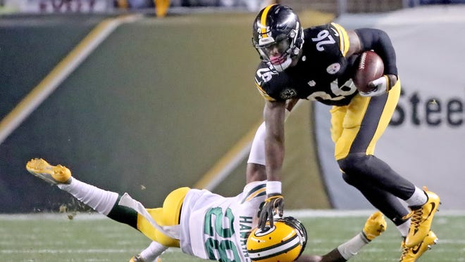 Green Bay Packers cornerback Josh Hawkins (28) misses a tackle on running back Le'Veon Bell (26) against the Pittsburgh Steelers at Heinz Field Sunday, November 26, 2017 in Pittsburgh, PA.
