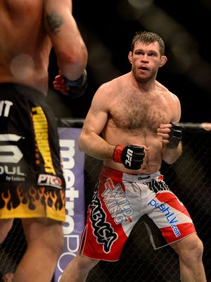 UFC fighter Forrest Griffin  takes on Tito Ortiz during a light heavyweight bout in UFC 148 at the MGM Grand Garden Arena.