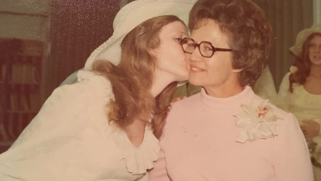 Bride Candace Cooksey Fulton kisses her mother, Bennie Cooksey, on the cheek July 20, 1974.