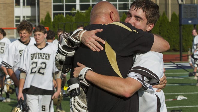 Southern Coach John Pampalone hugs goalie Brendan Lefanto as the team celebrate their Shore Conference Final title. Southern Regional vs Rumson-Fair Haven Boys Shore Conference Lacrosse Final on May 12, 2015.