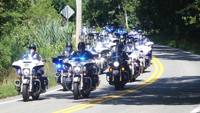 A police escort made up of patrols from all over the Cape and Plymouth leads the riders as they set out from the Barnstable County Sheriff's Office in Bourne. The ride headed head down-Cape along Route 6A through West Barnstable and on to Yarmouth.