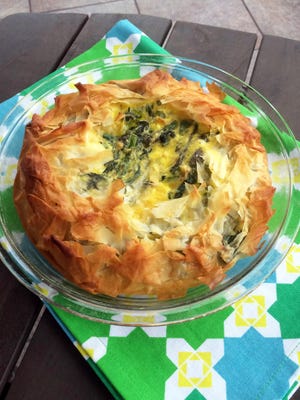Flaky phyllo dough encloses a cheesy spring vegetable filling in this pretty dinner dish.
