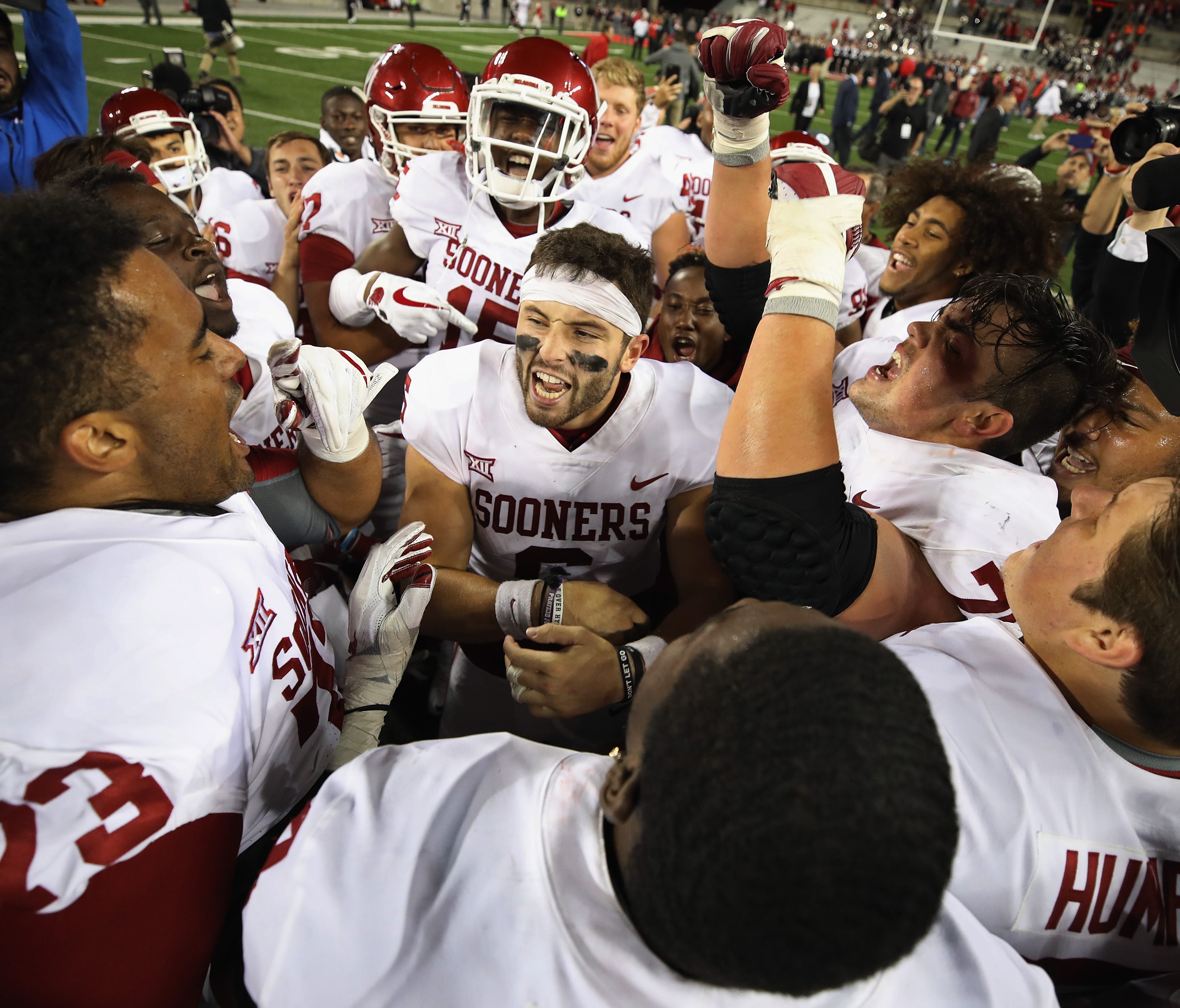 Oklahoma quarterback Baker Mayfield celebrates with teammates after their defeat of Ohio State in Ohio Stadium.