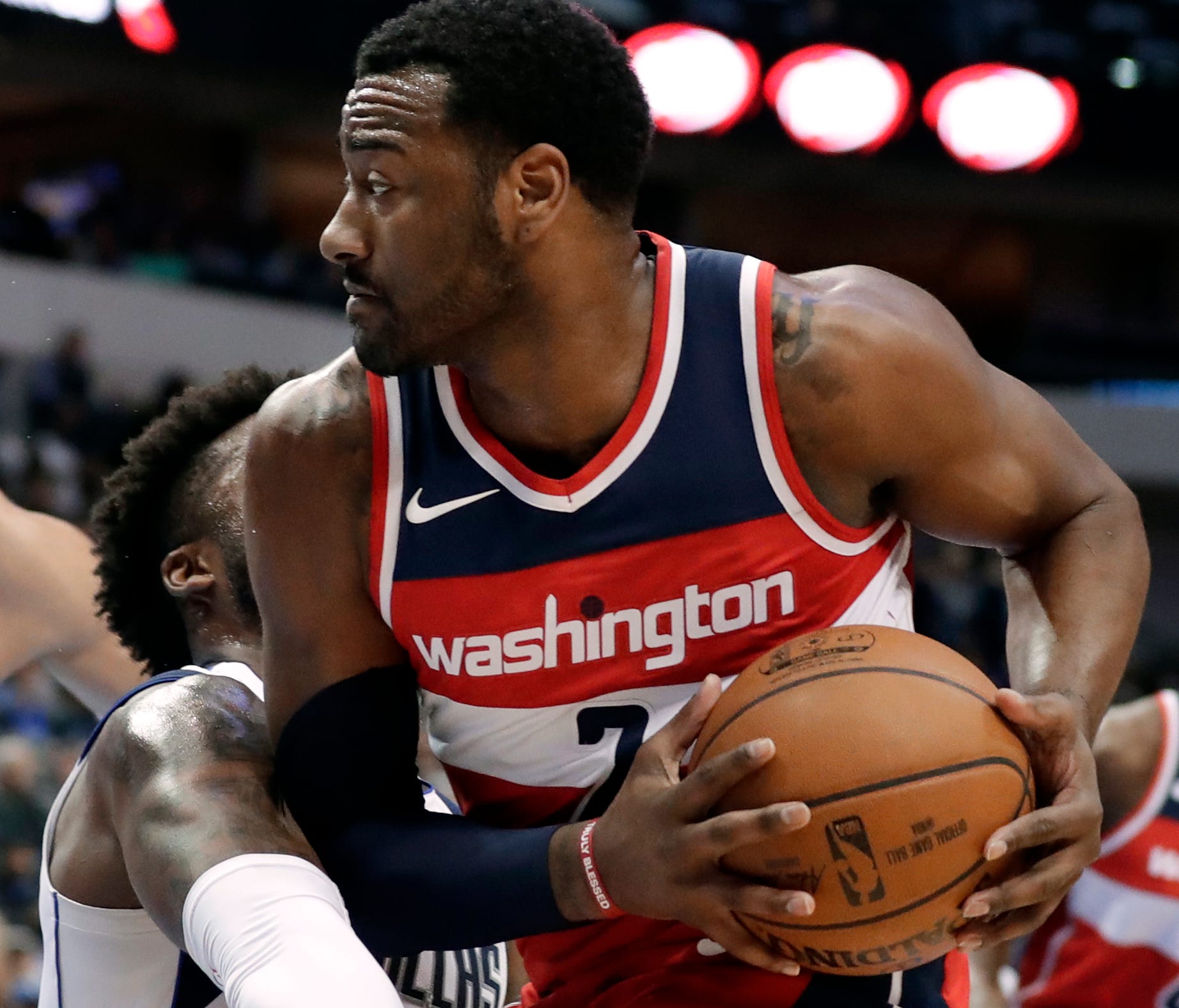 Dallas Mavericks guard Wesley Matthews, center left, and Salah Mejri (50), of Tunisia, defend as Washington Wizards' John Wall (2) works for a shot opportunity in the first half of an NBA basketball game, Monday, Jan. 22, 2018, in Dallas. (AP Photo/T