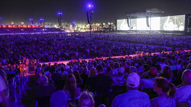 Jay Calderon/The Desert Sun
Concert goers watch Bob Dylan kick off the inaugural Desert Trip just after sunset on Oct. 7. The festival's two weekends of brought an unprecedented level of tourism business to the Coachella Valley in October.