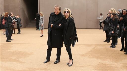 Model Kate Moss and photographer Mario Testino arrive for the Burberry Womenswear Autumn/Winter 2015 show at London Fashion Week in Kensington Gardens, west London Monday.