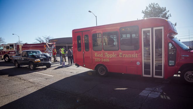 Emergency personnel clear the scene of an accident involving a Red Apple Transit bus on Tuesday at the intersection of West Broadway Avenue and South Orchard Avenue in Farmington.