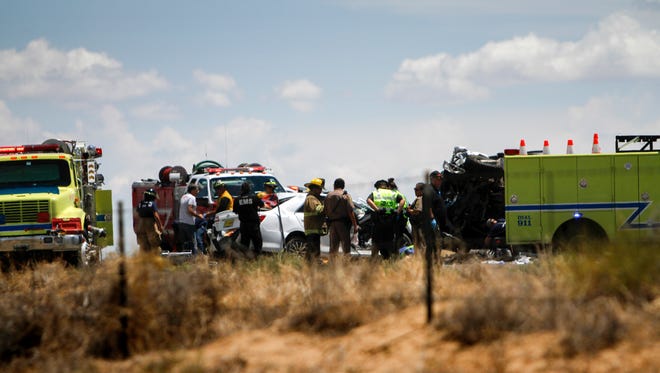 Emergency personnel work the scene of a fatal vehicle collision Friday near mile marker 15 on Navajo Route 36 in Nenahnezad.