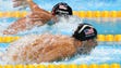 Michael Phelps (USA) races Ryan Lochte (USA) during