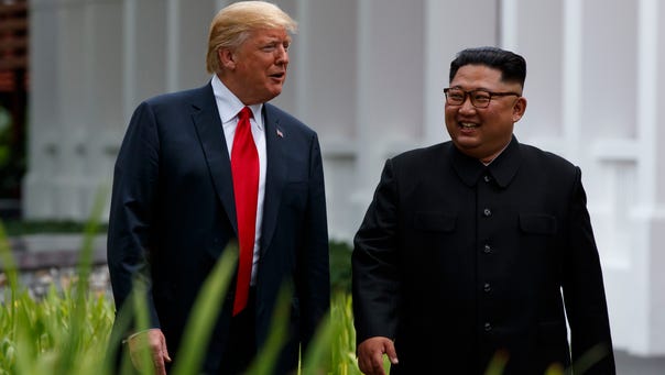 President Donald Trump walks with North Korean leader