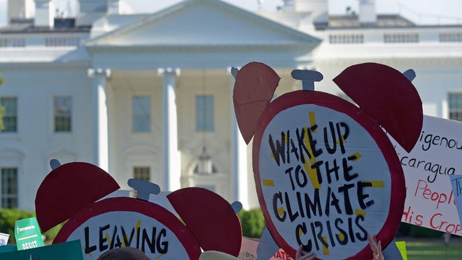 Protesters gather outside the White House in Washington, Thursday, June 1, 2017, to protest President Donald Trump’s decision to withdraw the Unites States from the Paris climate change accord.