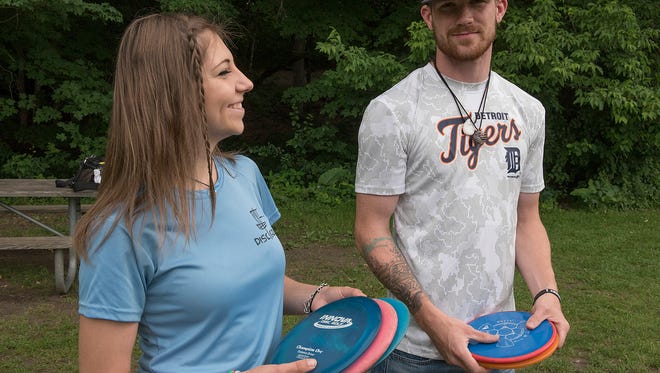 Disc Golfers Chelsie Huz and Ryan Derry, at Cass Benton Woods, in Northville.