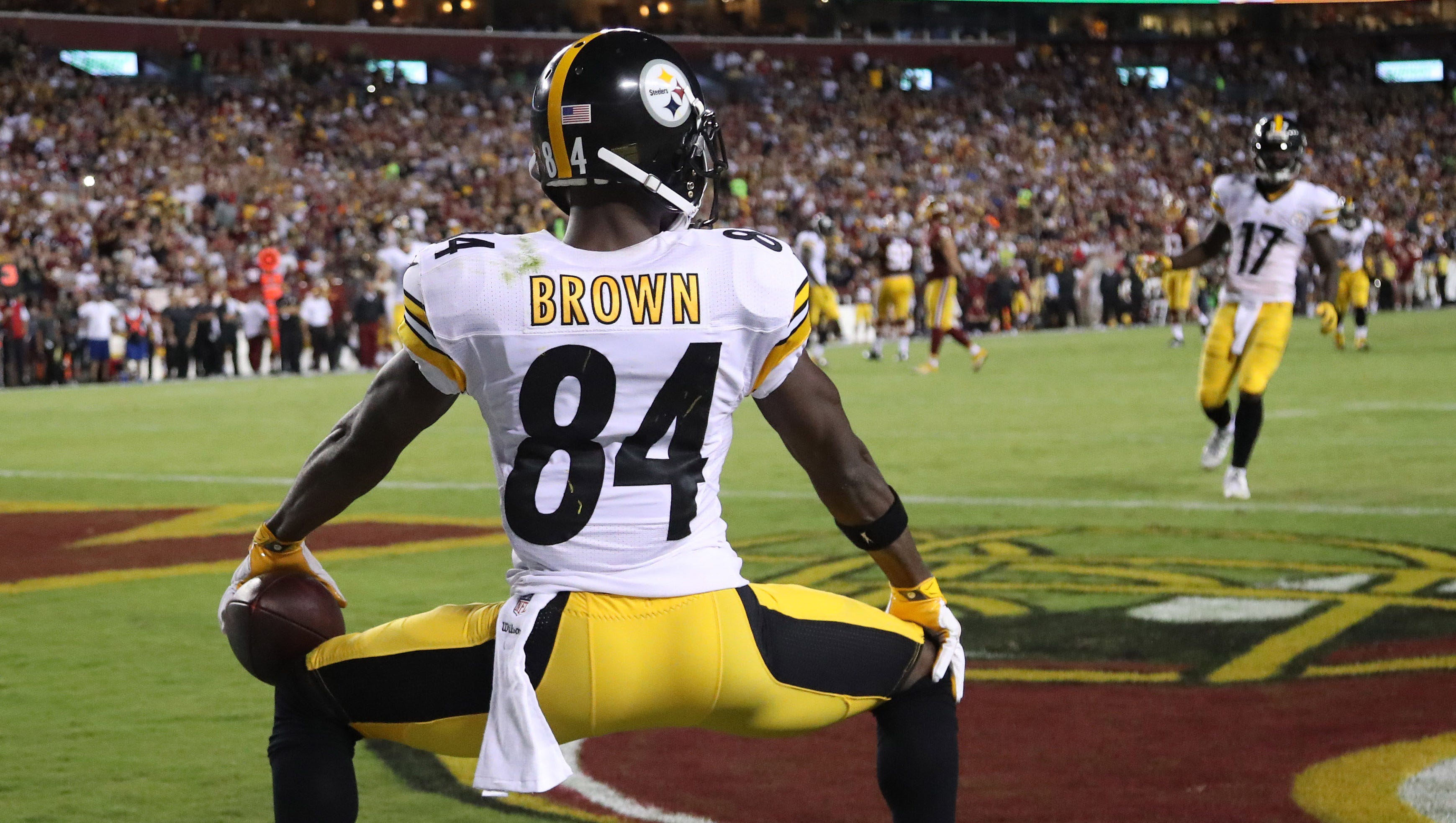 NFL players giving the ball to fans