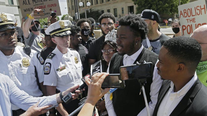 Activist Earl Jones speaks to the media outside of the Columbus Division of Police headquarters Downtown after a meeting involving police officials and Black activists on Monday, June 8, 2020.