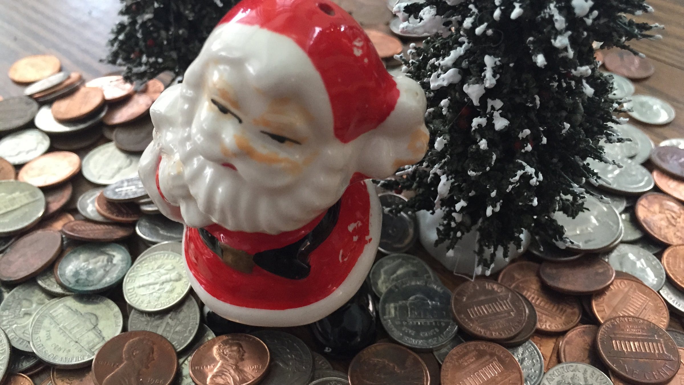 Santa counts pennies and changes coins for gift cards