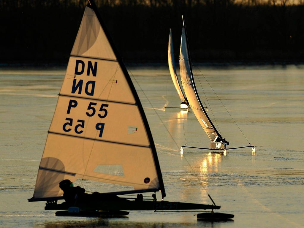 Ice yachting boats glide along the smooth ice of frozen Tisza Lake in Abadszalok, 92 miles east of Budapest, Hungary.