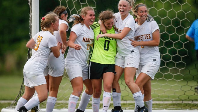 Members of the Ankeny High School girls' soccer team celebrate with sophomore goal keeper Brenny Frederick after Frederick stopped a shot to beat West Des Moines Valley during the Class 3A state semifinals in 2018.