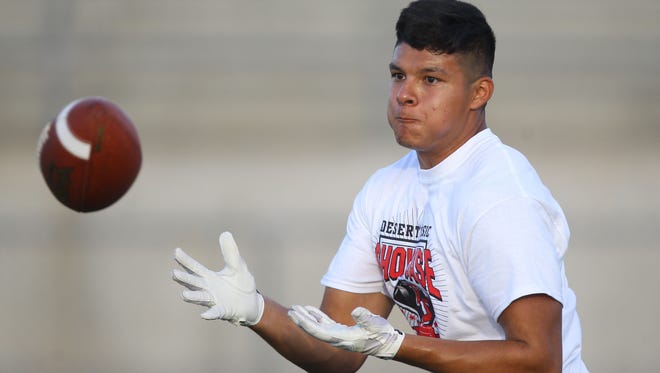 Sammy Venegas, of Shadow Hills High School runs a drill during a football combine for prospective college football players in the valley at Palm Springs High School on May 13, 2016. 