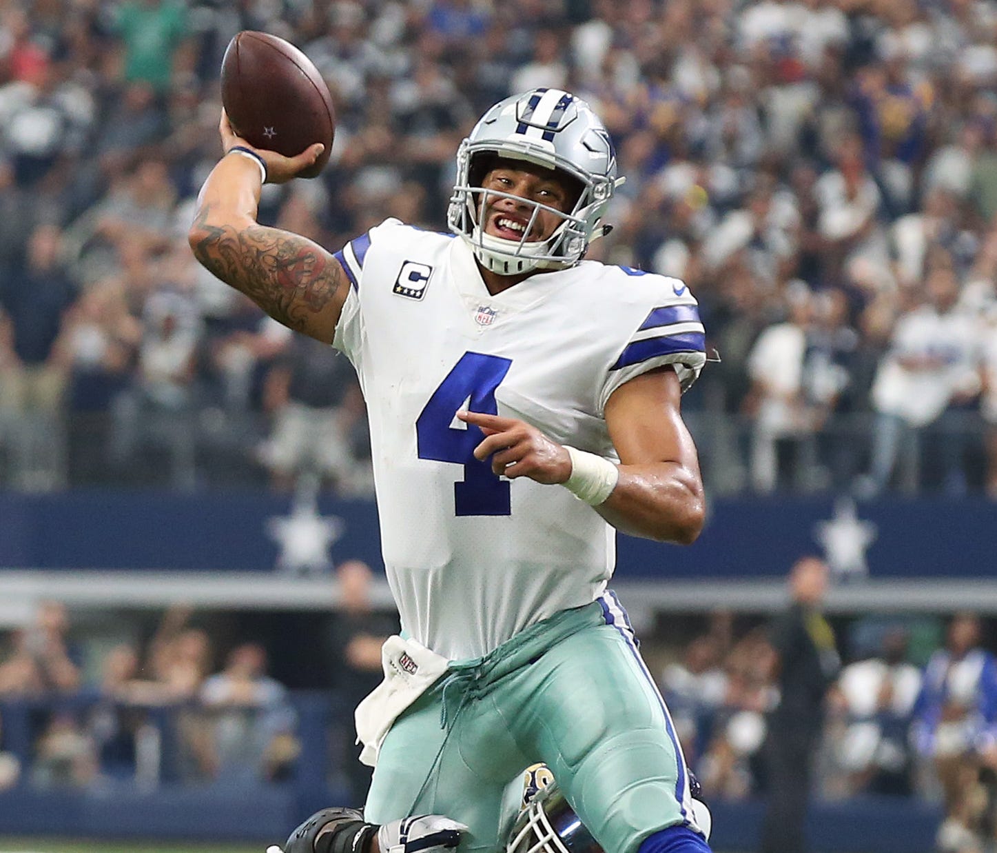 Dallas Cowboys quarterback Dak Prescott (4) throws under pressure from Los Angeles Rams linebacker Alec Ogletree (52) during a two point conversion attempt in the fourth quarter at AT&T Stadium.