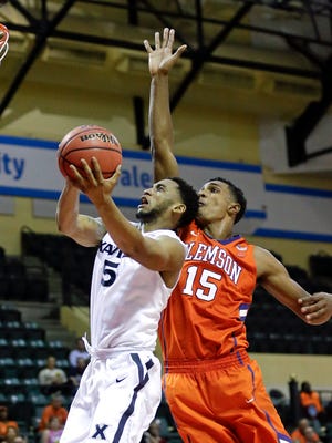 Xavier's Trevon Bluiett (5) makes a shot in front of Clemson's Donte Grantham (15) during the second half of an NCAA college basketball game at the Tire Pros Invitational tournament, Friday, Nov. 18, 2016, in Lake Buena Vista, Fla. Xavier won 83-77. (AP Photo/John Raoux)