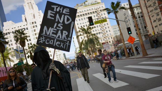 A participant holds a 'Calexit' sign during the Women's March on Jan. 21, 2017 in Los Angeles.