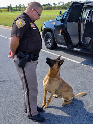 K-9 officer, Baco, waits for his ball from handler, Deputy Dan Wachowiak, in the Portage County Business Park in August 2013.