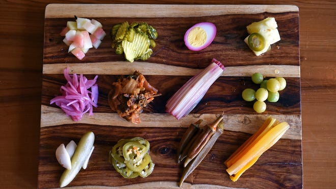 Various pickled items, such as pineapple, eggs, watermelon rind, onions and Swiss chard stems, add color and snap to the plate at Parlor Market in downtown Jackson.