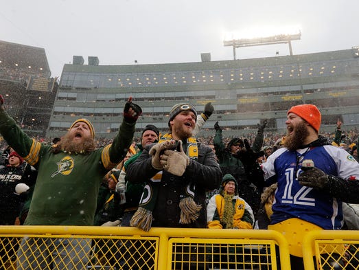 Packers fans celebrate after a defensive stop on third