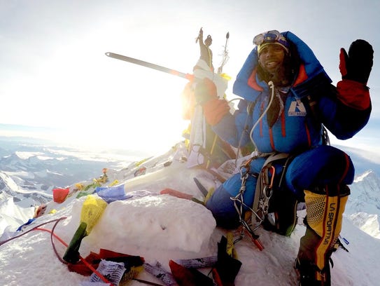 Neal Kushwaha poses at the summit of Mount Everest.