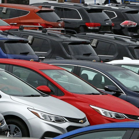 Chevrolet cars are positioned on a dealer lot in P