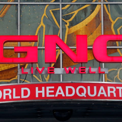 File photo shows a corporate sign at GNC's world h