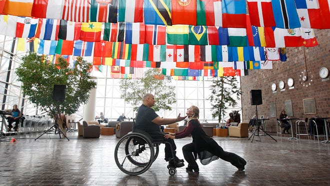 "Wheels in Motion," featuring Miguel Rotiz, Rochester, left, and Lorene Benson, Farmington, right, perform a dance number as part of the "Spread the Word to End the Word" day of awareness Wednesday, March 5, 2014 at the University of Rochester's Wilson Commons.