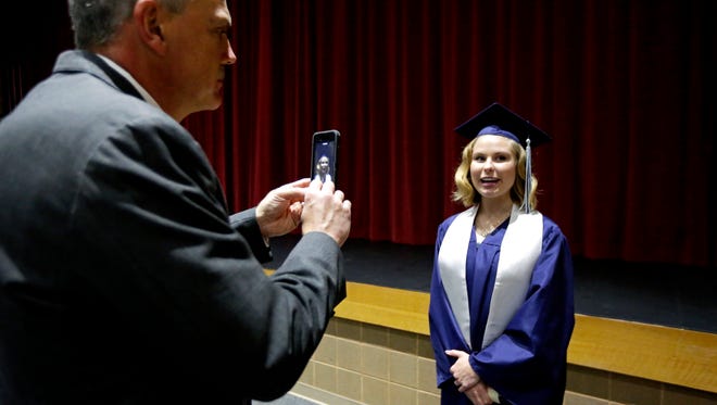Superintendent Dave Botz takes a video of Sadie Olson recalling a favorite memory of a teacher that will be retiring as seniors take part in graduation activities at Little Chute High School in May 2016. With Botz retiring at the end of the year, the district is searching for his successor.
