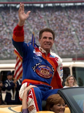 Darrell Waltrip waves to the crowd before the start