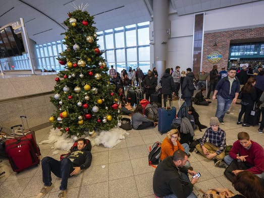 Passengers affected by a widespread power outage wait