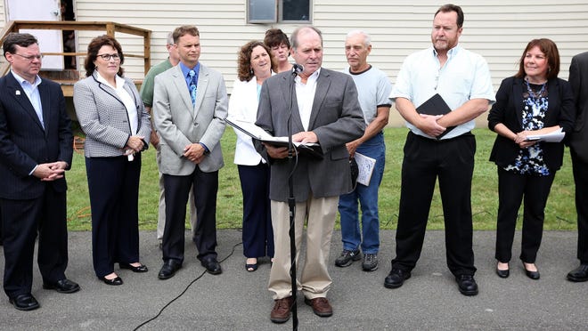 Tioga County Farm Bureau president and member of the Snyder Farm Group Kevin Frisbie announces Wednesday, July 8, the five-farm family group's intentions to install a natural gas well underneath a hayfield in the Town of Barton. A press conference was held outside the town hall.