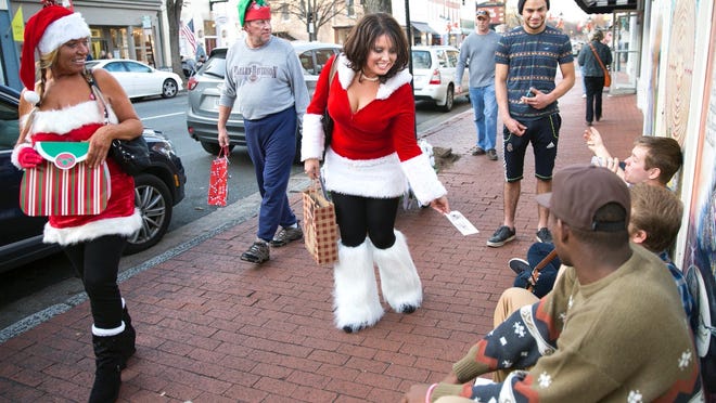 Tiffany Neace celebrates her 40th birthday by handing out lottery tickets and toys in downtown Fredericksburg, Va., on Dec. 12. Because it was so much fun, she said, “This is going to be my new birthday tradition.”