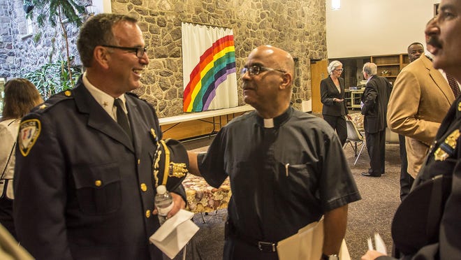(L-R) Morristown Police Chief Pete Demnitz and Pastor Robert Rogers, Pastor of Church of God in Christ for All Saints, at the Interfaith Vigil for Peace and Justice at the Morristown Methodist Church-on-the-Green in Morristown, July 13, 2016.
