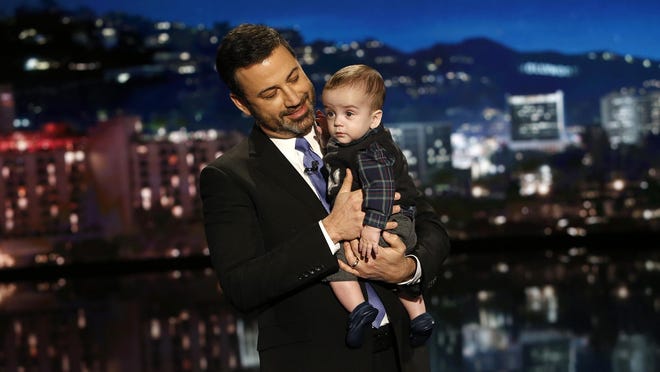 This Dec. 11, 2017 image released by ABC shows host Jimmy Kimmel with his son Billy on "Jimmy Kimmel Live!" Kimmel held his baby son as he returned to his late-night show after a week off for the boy's heart surgery. Kimmel kept up his ardent advocacy Monday night, urging Congress to restore the Children's Health Insurance Program, which has been left unfunded and stuck in a political stalemate since September.