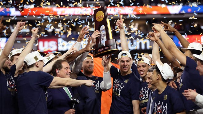 The Virginia Cavaliers celebrate with the trophy after their 85-77 win over the Texas Tech Red Raiders during the 2019 NCAA men's Final Four National Championship game at U.S. Bank Stadium on April 8, 2019 in Minneapolis, Minn. (Streeter Lecka/Getty Images/TNS)