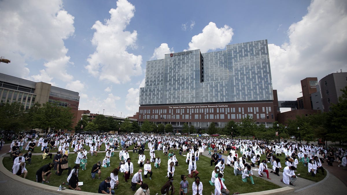 Doctors, nurses, medical students, and staff take a knee for eight minutes and 46 seconds, in front of the James Cancer Hospital, in solidarity with the Black Lives Matter movement, Friday, June 5, 2020.