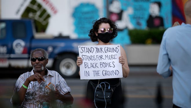 Supporters and opponents of Ohios new stand your ground law are preparing for the law to take effect Tuesday In this June 2020 file photo Eddie Moncrief left and Katie Harriman right stand in front of the Ohio Statehouse