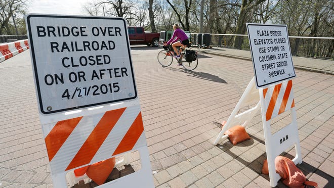 Signs alert pedestrians and cyclists on the West Lafayette side of the John T. Myers Pedestrian Bridge Wednesday, April 15, 2015, that the Riehle Plaza/Depot Bridge over the CSX and N&S tracks will be closed on or after April 27. People can still access the Amtrak platform, however, they will have to so from the West Lafayette side of the Myers Pedestrian Bridge.