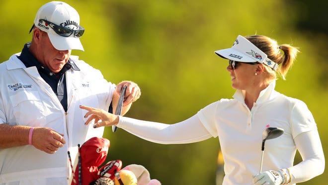 First round leader Morgan Pressel wipes something off her caddie's jumpsuit while waiting to hit her drive on the 18th tee at the ANA Inspiration on Thursday in Rancho Mirage. Pressel birdied the hole and took sole possession of the lead at 5-under.