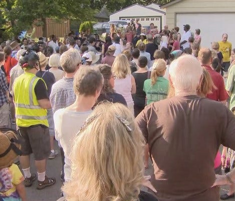 Hundreds of people gathered at the entrance of an alleyway in southwest Minneapolis to mourn the woman who was shot and killed by police there on Saturday night.