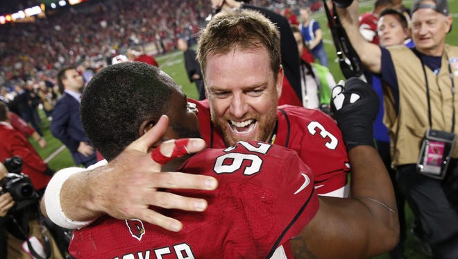 Arizona Cardinals QB Carson Palmer celebrates with DE Frostee Rucker after beating the Green Bay Packers 26-20 in OT in the NFC divisional playoff game in Glendale, Ariz. January 16, 2016.