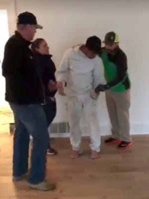 This Thursday, Oct. 19, 2017, photo taken from video provided by George Cardenas shows federal immigration agents arresting a worker even though they acknowledged they lacked a warrant to enter the home near Beaverton, Ore.