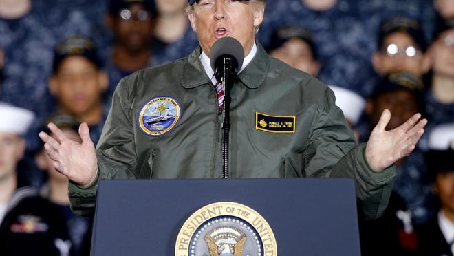 In this March 2, 2017, photo, President Donald Trump gestures as he speaks to Navy and shipyard personnel aboard nuclear aircraft carrier Gerald R. Ford at Newport News Shipbuilding in Newport News, Va. Facing a new wave of questions about his ties to Russia, Trump is telling advisers and allies that he may abandon, at least temporarily, his plan to pursue a deal with Moscow on the Islamic State group and other national security matters, according to administration officials and a Western diplomat. (AP Photo/Steve Helber)