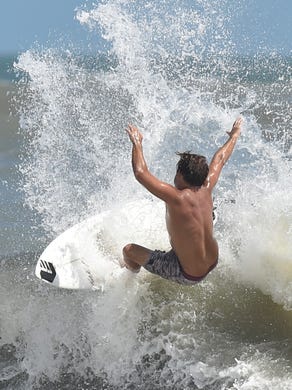 Surfers ride the waves at Fort Pierce Inlet State Park as swells from Hurricane Maria kick up the surf on Monday, Sept. 25, in Fort Pierce. 